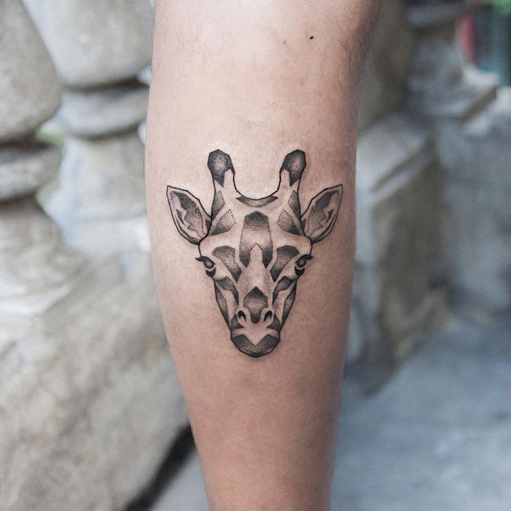 Giraffe tattoo on the calf for woman