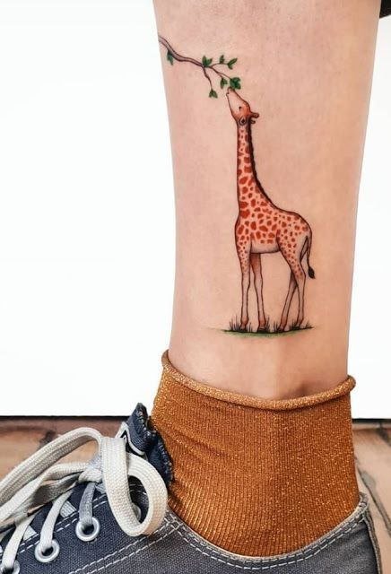 Giraffe tattoo on the shin for women