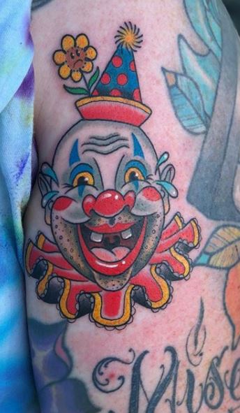 Tattoo of a clown on the hip 