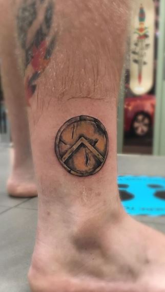 Spartan tattoo on the shin for men