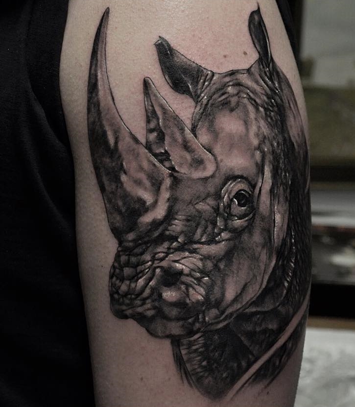 Rhinoceros tattoo on the shoulder for men