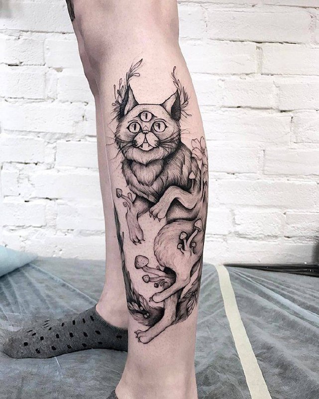 Cat tattoo on the shin for men