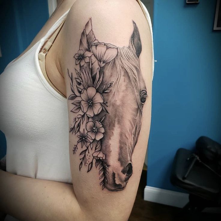 Tattoo of a horse on the shoulder for women