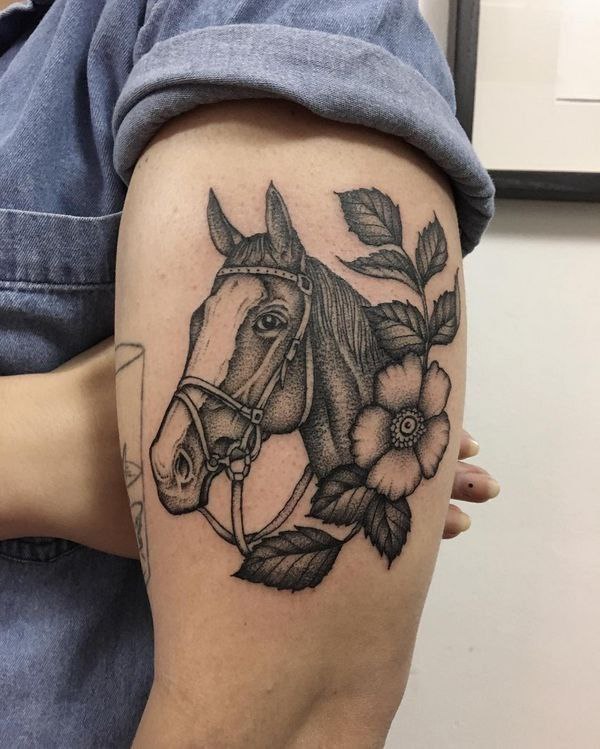 Tattoo of a horse on the shoulder for women