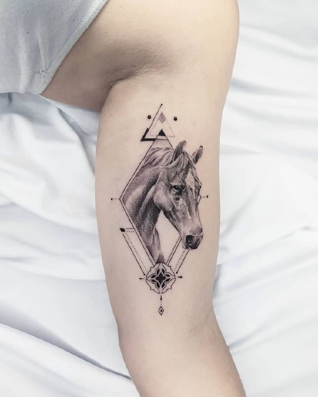 Tattoo of a horse on the biceps for women