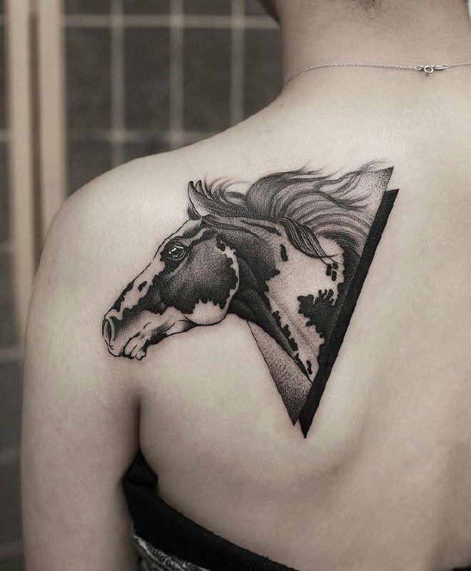 Horse tattoo on the shoulder blade for women