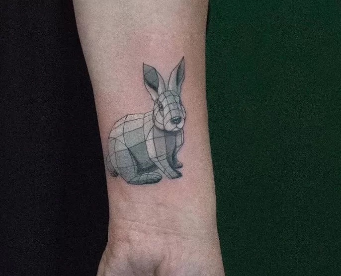 Tattoo of a hare (rabbit) on the arm for women