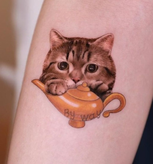 Cat tattoo on the forearm for women