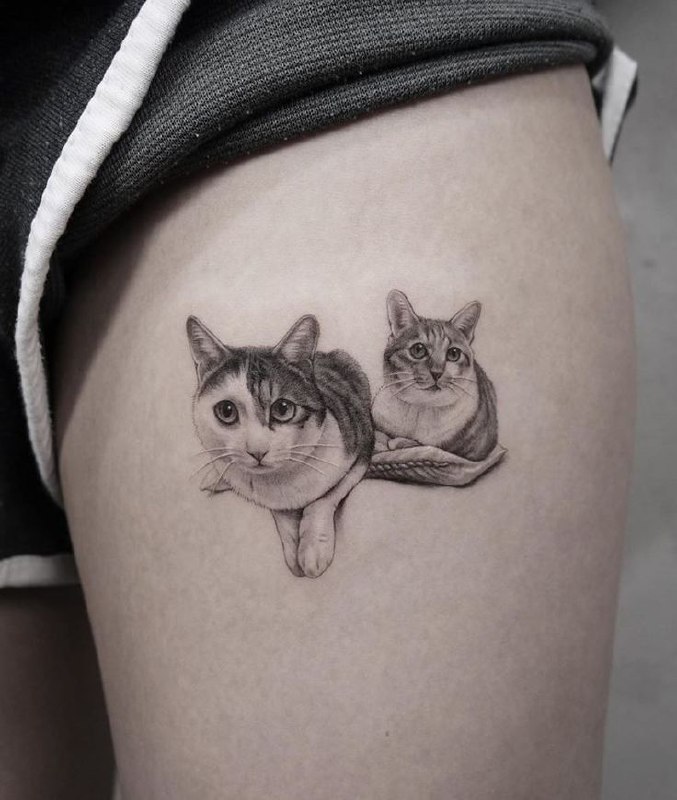 Cat tattoo on the hip for women