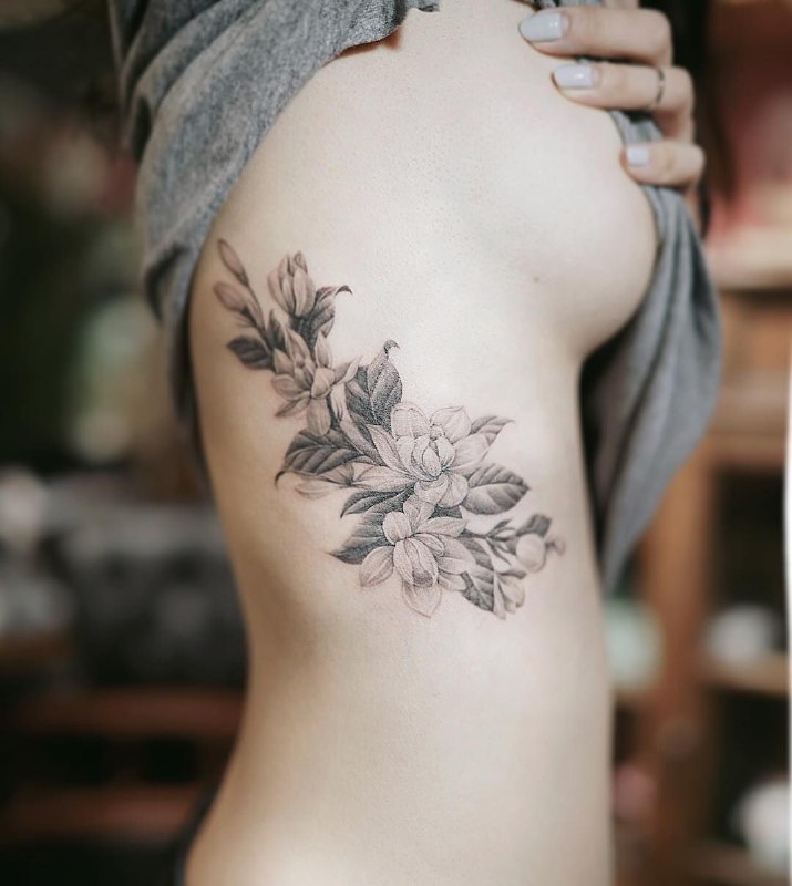 Jasmine tattoo on the side for women