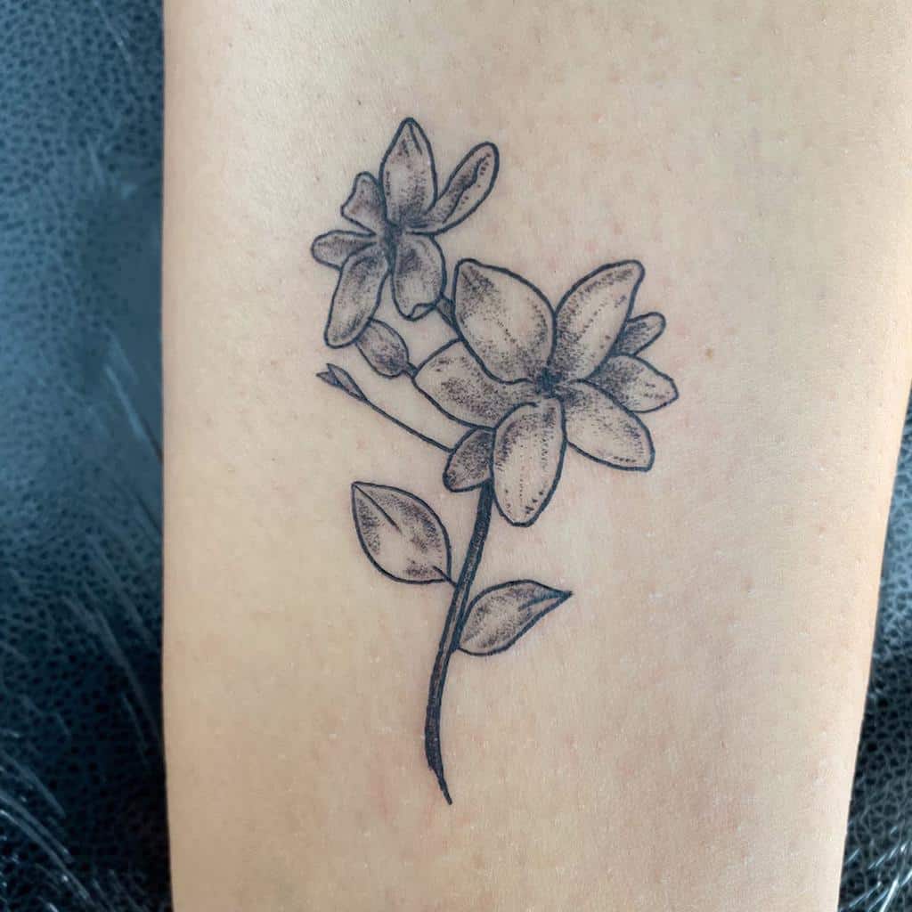 Jasmine tattoo on the leg for women