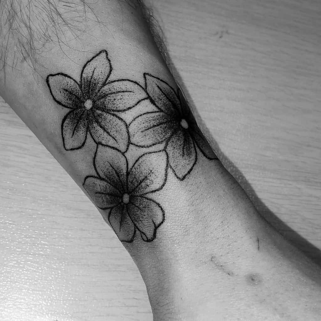 Jasmine tattoo on the forearm for men