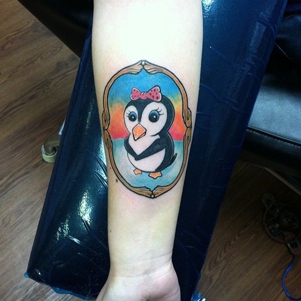 Tattoo of a penguin on the forearm for women