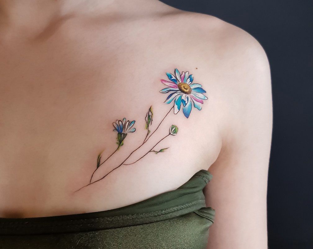 Colorful daisy tattoo on the chest for women