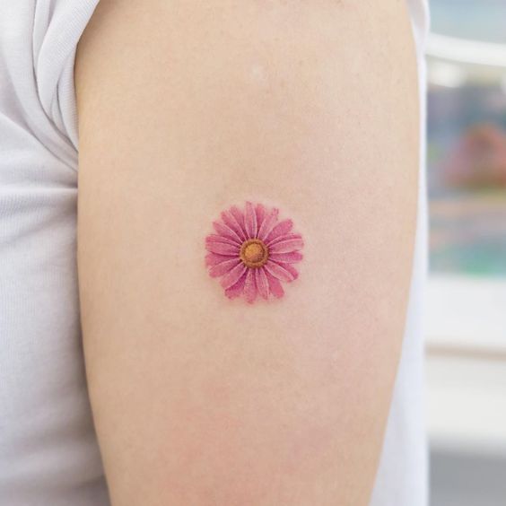 Colorful daisy tattoo on the shoulder for women