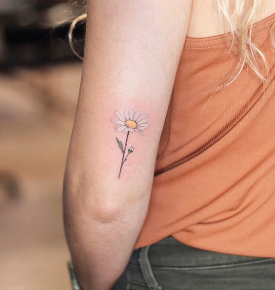 Colorful daisy tattoo on the shoulder for women