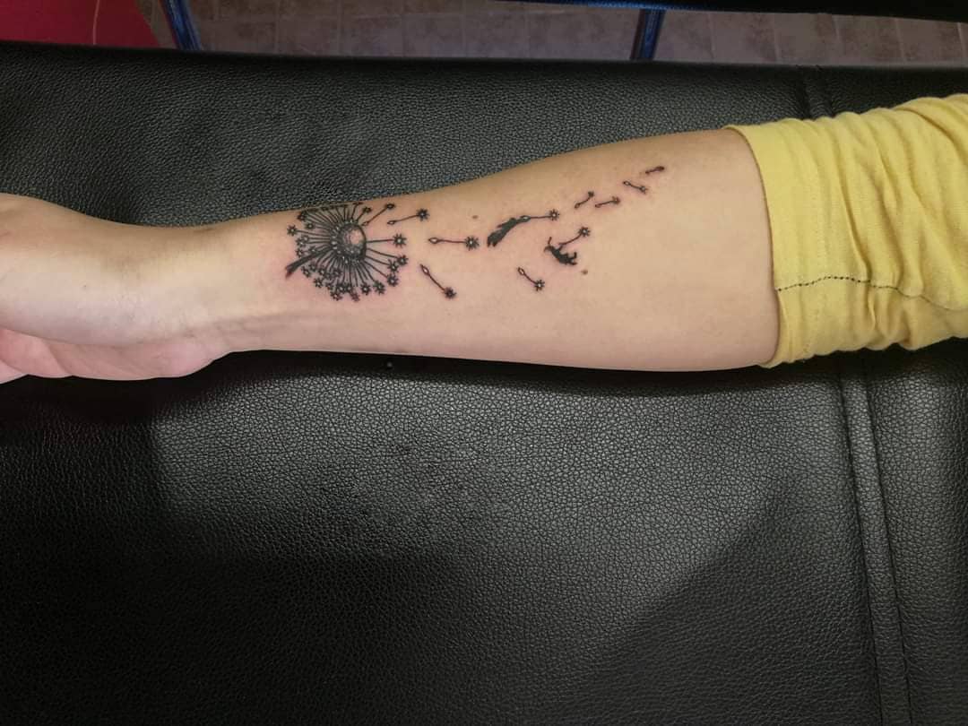 Dandelion tattoo on forearm for women