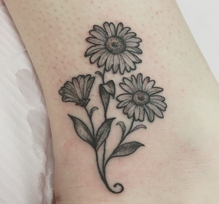 Daisy tattoo on ankle for women