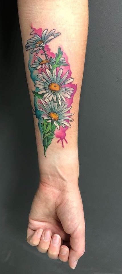 Large daisy tattoo on the arm for men