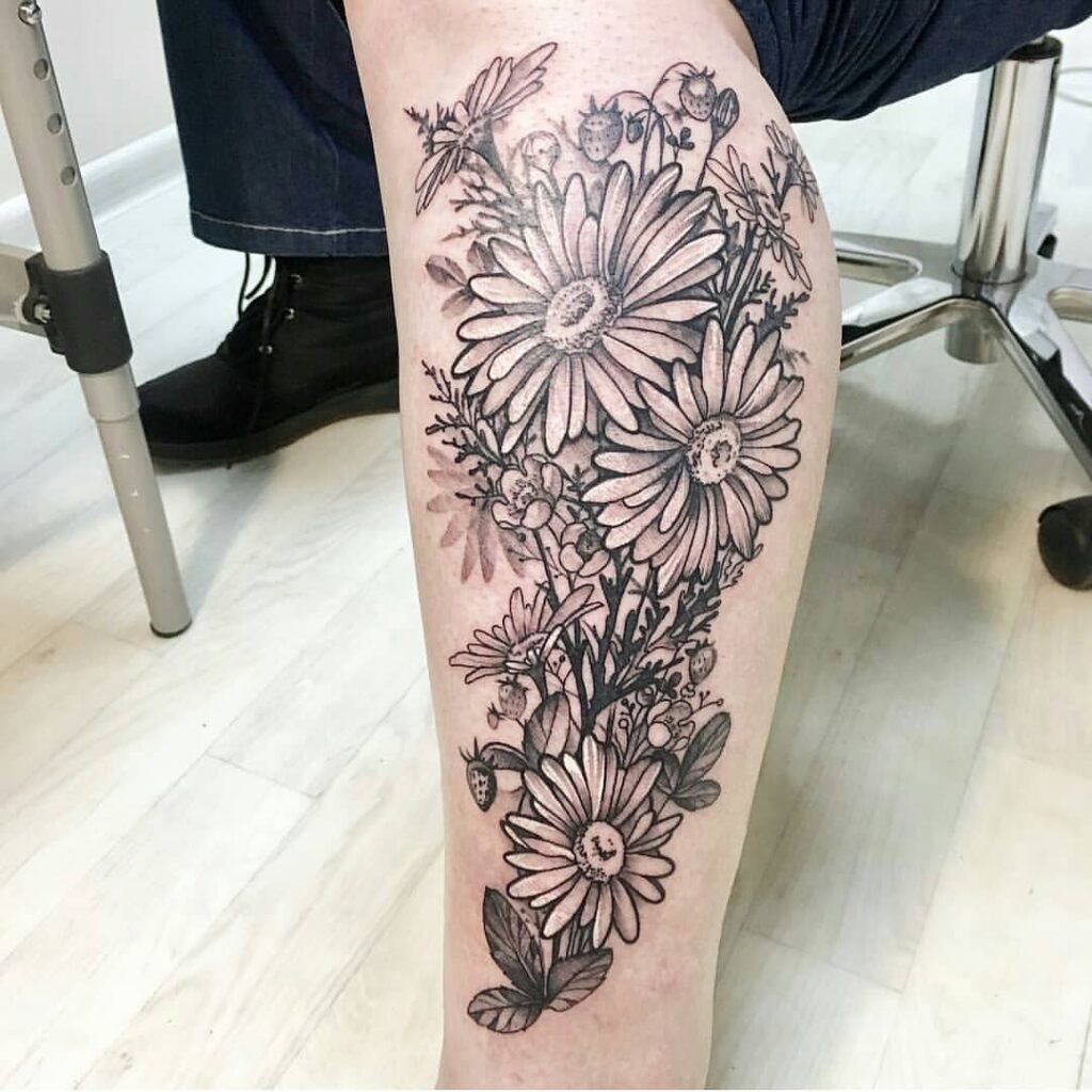 Large daisy tattoo on the shin for men