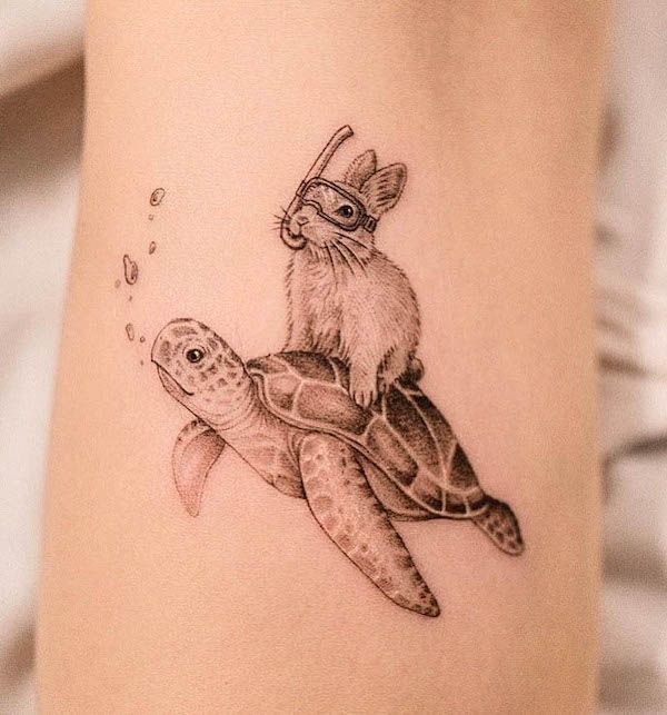 Tattoo of a turtle with a hare on the arm for women