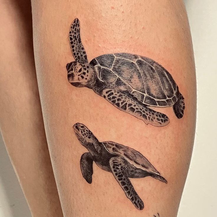 Tattoo of two turtles on the shin for women