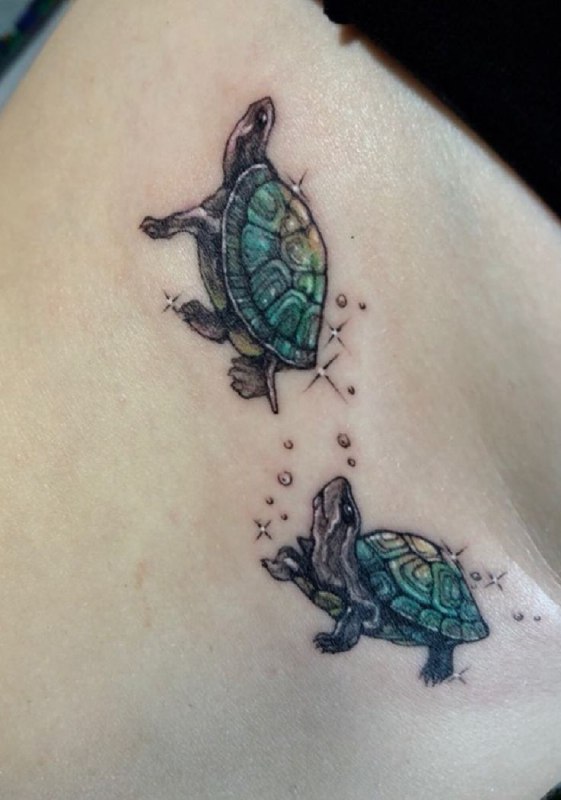 Tattoo of two turtles on the thigh for women