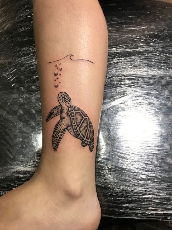 Turtle tattoo on the shin for women