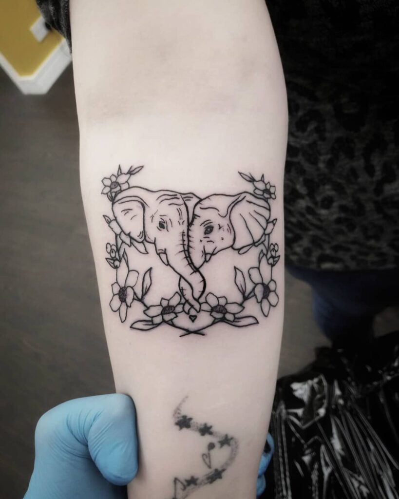 Tattoo of two elephants on the forearm for women