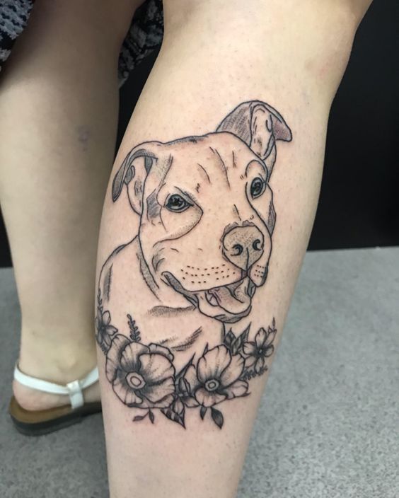 Dog tattoo on the shin for women