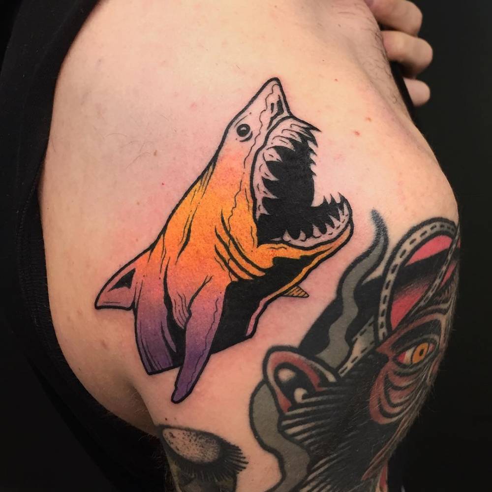 Colored shark tattoo on the shoulder blade for men