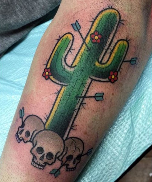 Colorful cactus tattoo with skulls on the shin for women