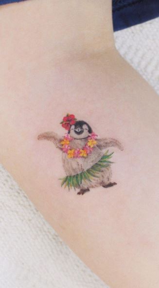 Penguin tattoo on the forearm for women