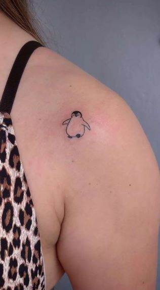 Penguin tattoo on the shoulder for women