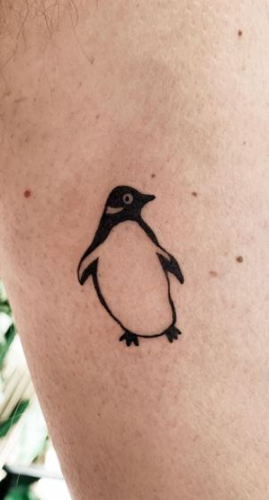 Tattoo of a penguin on the forearm for men