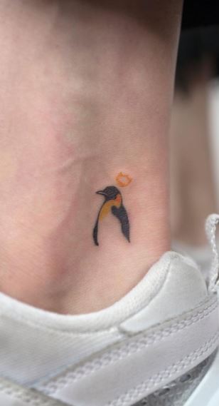 Tattoo of a penguin on the ankle for men