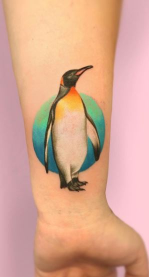 Penguin tattoo on the forearm for women