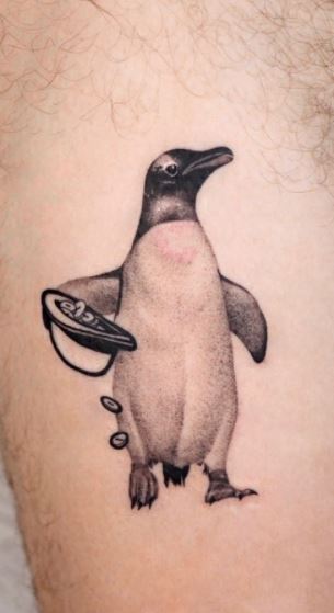 Tattoo of a penguin on the leg for men