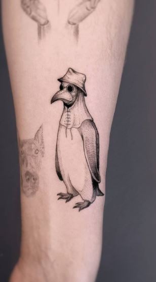 Tattoo of a penguin on the forearm for men