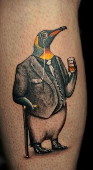 Tattoo of a penguin on the shin for men