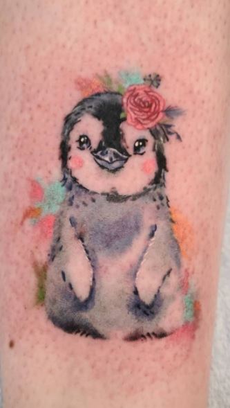 Tattoo of a penguin on the leg for women