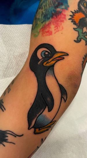 Tattoo of a penguin on the forearm for men