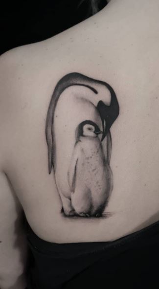 Penguin tattoo on the shoulder blade for women