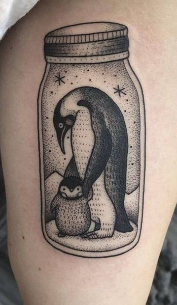 Tattoo of a penguin on the shoulder for men