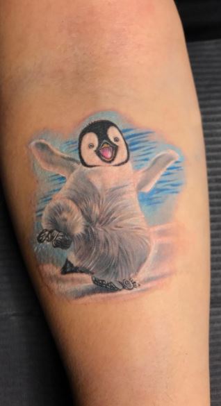 Penguin tattoo on the forearm for women