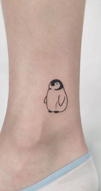 Penguin tattoo on the shin for women