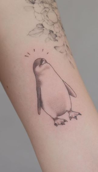 Penguin tattoo on the shoulder for women