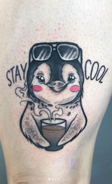 Penguin tattoo on the thigh for men