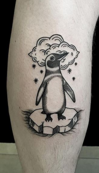 Tattoo of a penguin on the leg for men