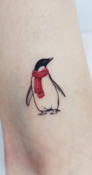 Tattoo of a penguin on the shoulder for men